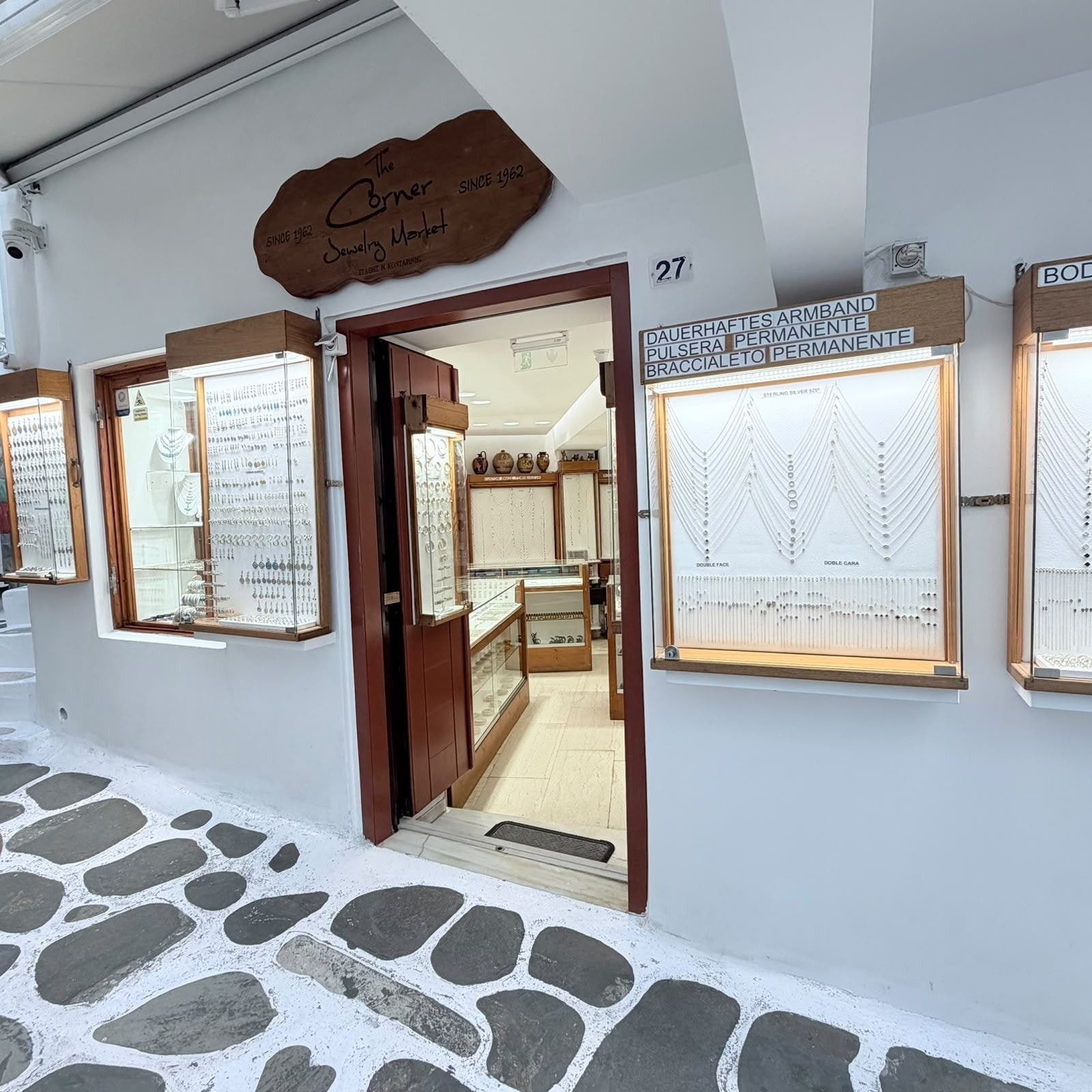 The shop front of The Corner Jewelry Market on Kouzi Georgouli, Little Venice: the wooden sign, the open door and the window displays